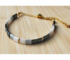 Armband Miyuki Tila kralen zwart/wit/grijs met goudkleur en rvs schuifknoop
