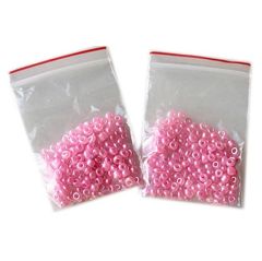 Zakje rondelkralen 3x2mm glanzend roze, per 150 stuks.