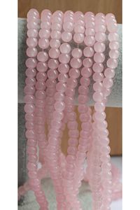 Snoer ronde beetje transparant creme-roze glaskralen 6mm. 48-50 kralen.