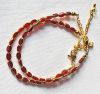 Armband facetgeslepen wijnrood-goudkleurige kralen 5x3mm