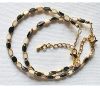 Armband facetgeslepen zwart en wit met goudkleur kralen 5x3mm