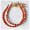 Armband facetgeslepen opaque rode kralen met goudkleur 5x3mm